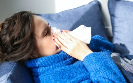 woman with a blue sweater with a cold