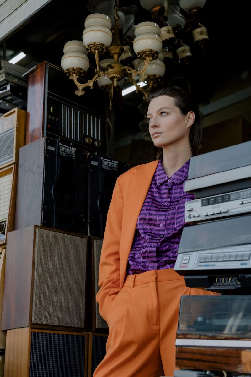 woman with orange suit and purple shirt