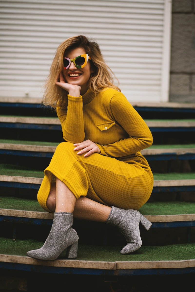 woman with yellow body suit and glasses