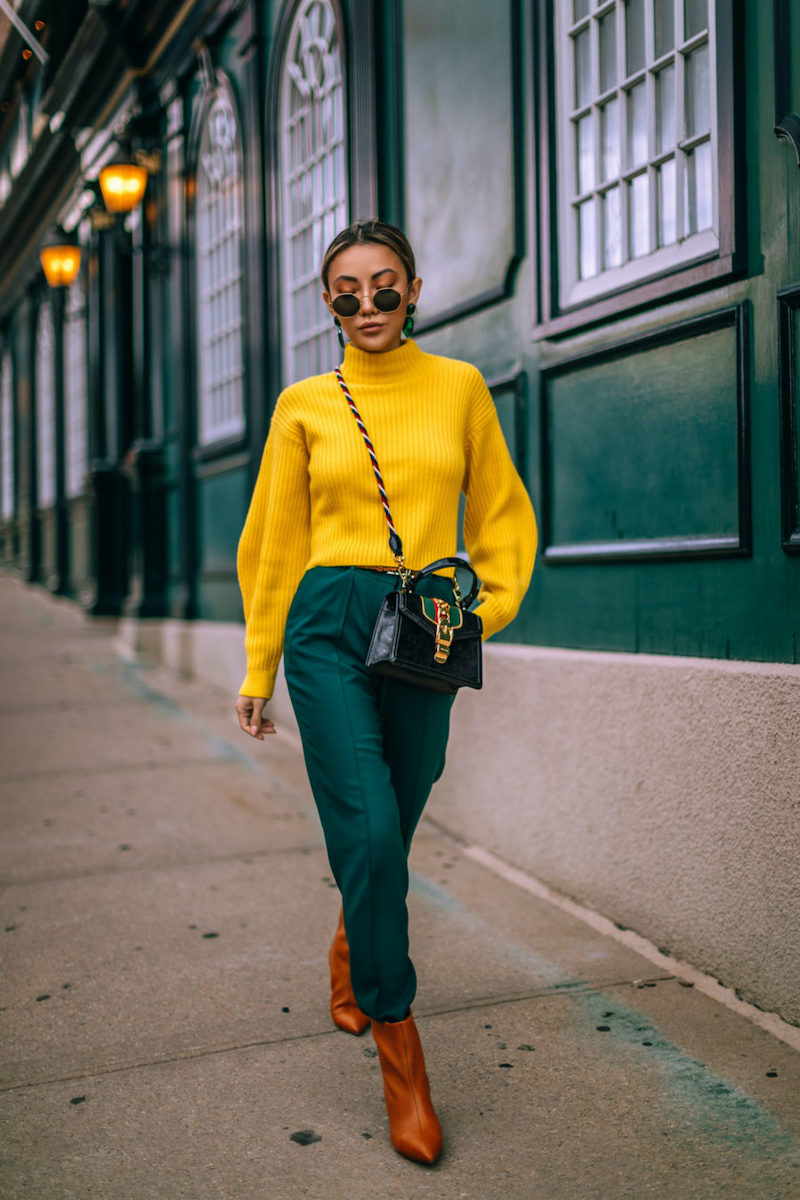 woman with yellow sweater and green pants