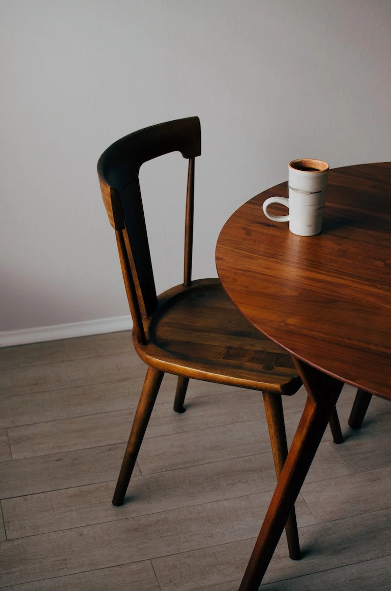 wooden chair and table with cup on table