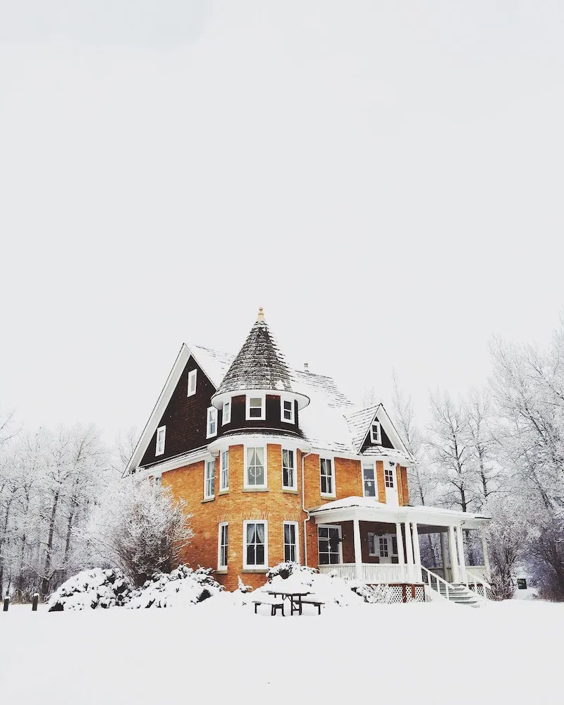 yellow house under a snow