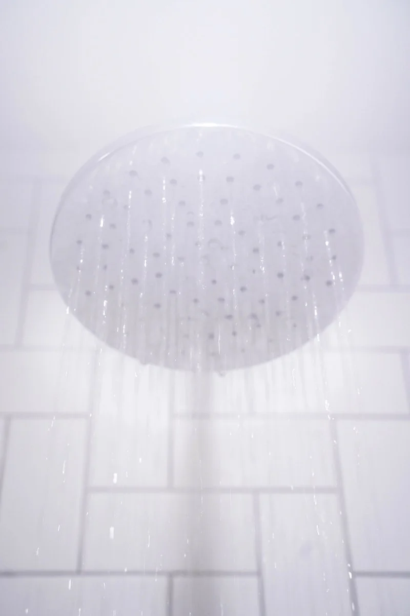 a white shower head running with water