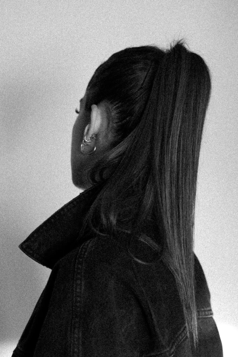 black and white picture of a womans ponytail