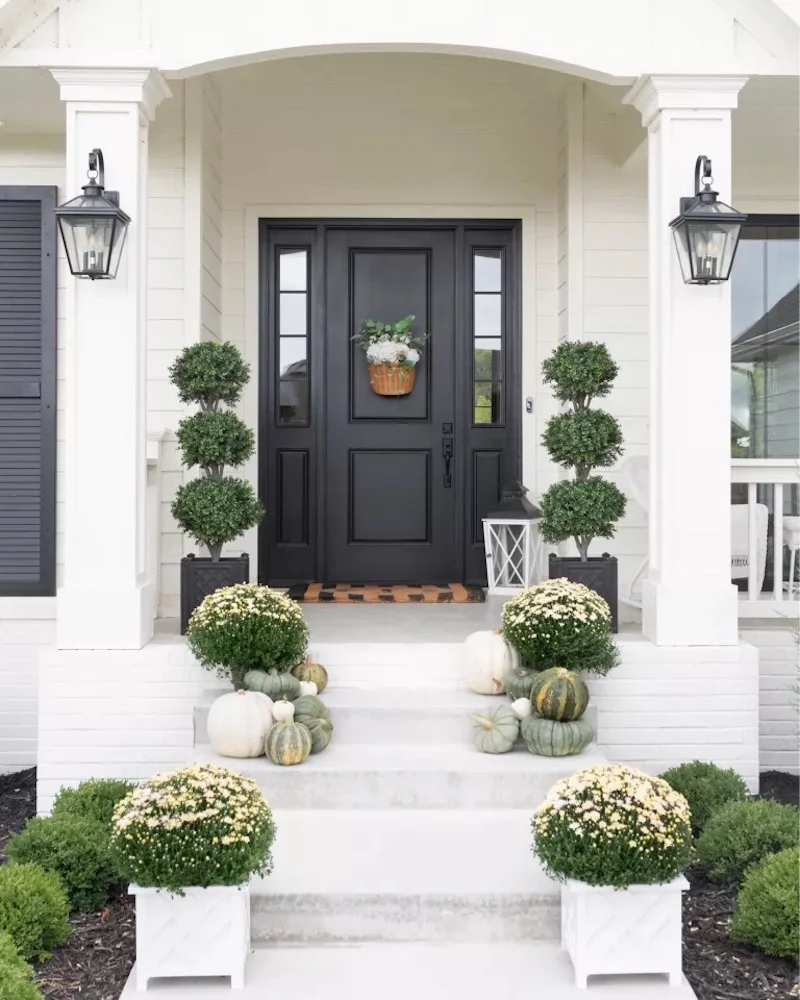 black and white porch with neutral pumpkins