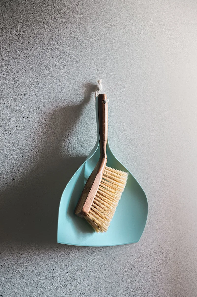 blue dust pan and small broom