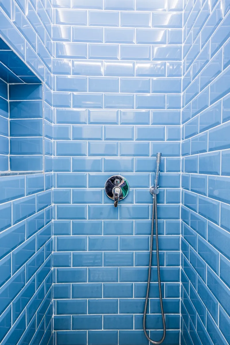 blue tile bathroom with white grout