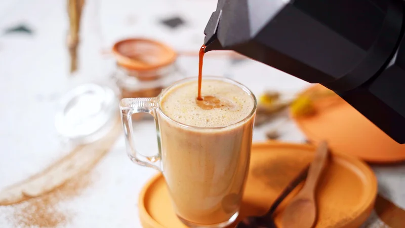 coffee being poured in a latte