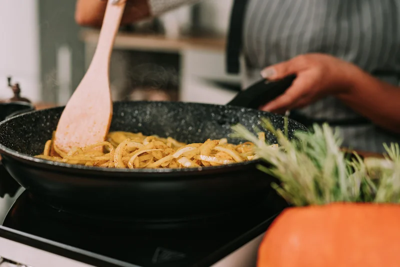 cooking onions in a pan with spices