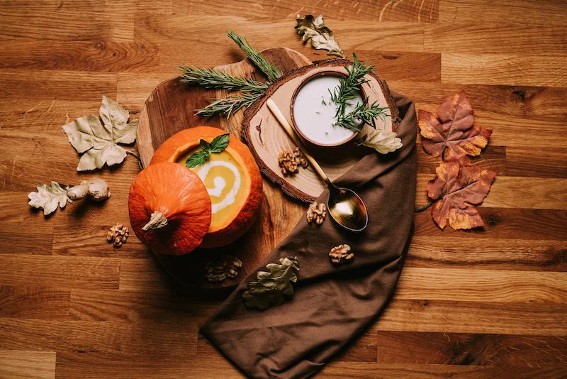 creamy vegan pumpkin soup in a carved out pumpkin