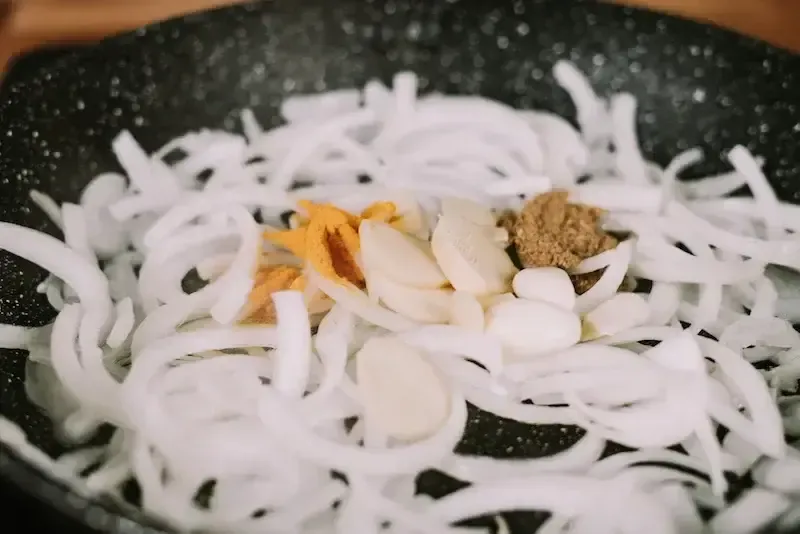 cumin turmeric garlic onions in a pan