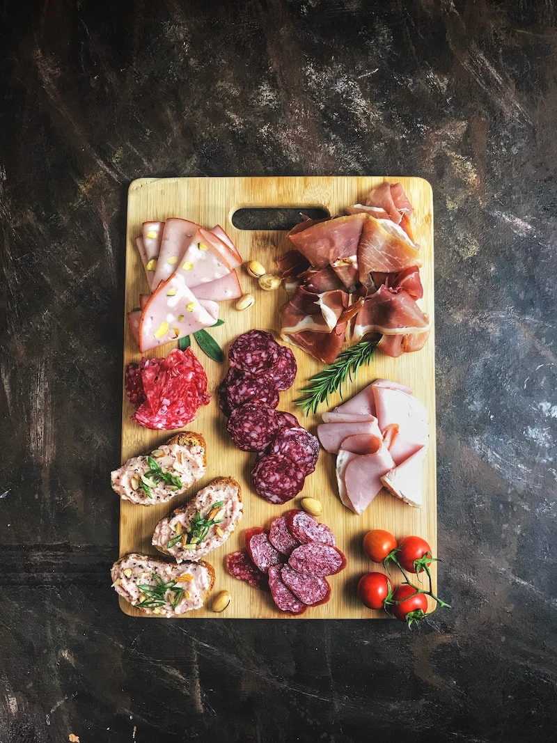 different types of cured meats on a board