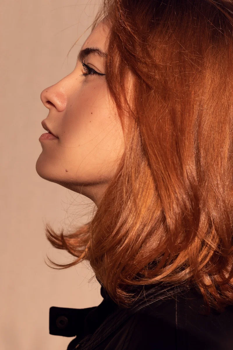 facial exercises side profile of a ginger woman