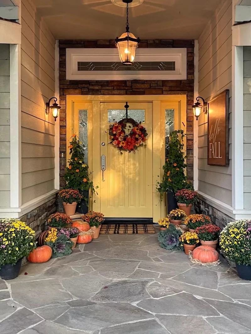 fall porch decor yellow door with flowers