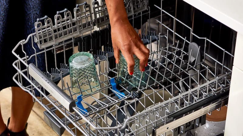 glass being put0in the dishwasher