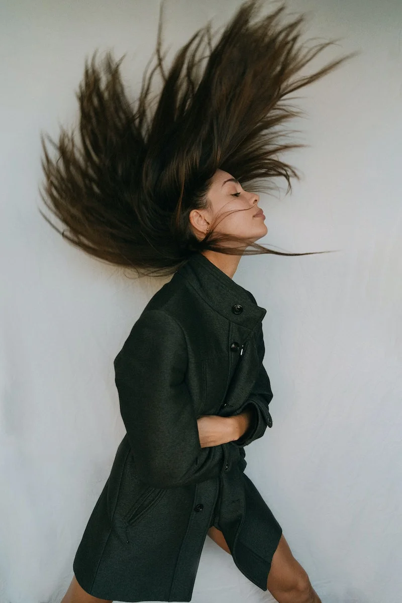 hair myths woman throwing her hair in the air