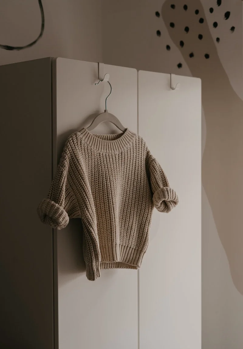 how to wash sweaters brown sweater hanging on a hanger