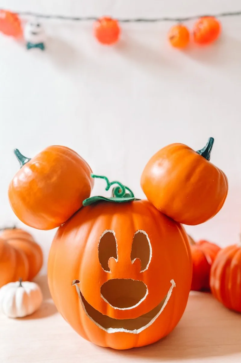 mickey mouse carved pumpkin with mini pumpkins