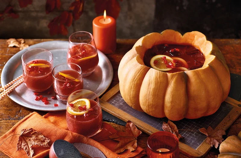 pumpkin carved into a punch bowl