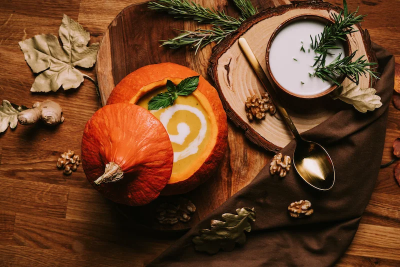 pumpkin soup served in a carved out pumpkin bowl