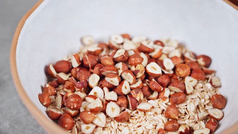 raw hazelnuts and oats in a bowl