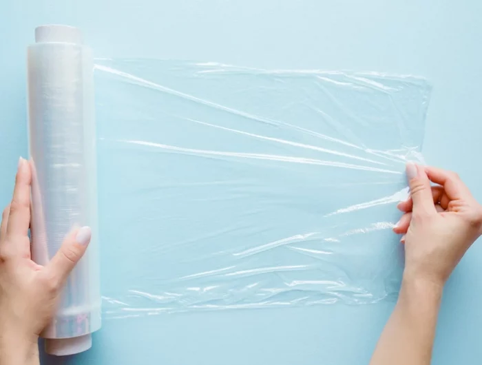 roll plastic wrap on blue background