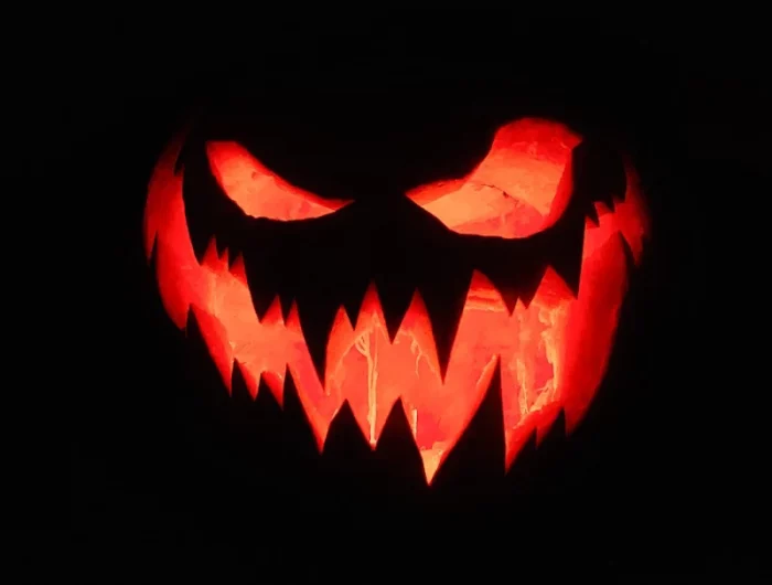 scary halloween pumpkin lit in dark