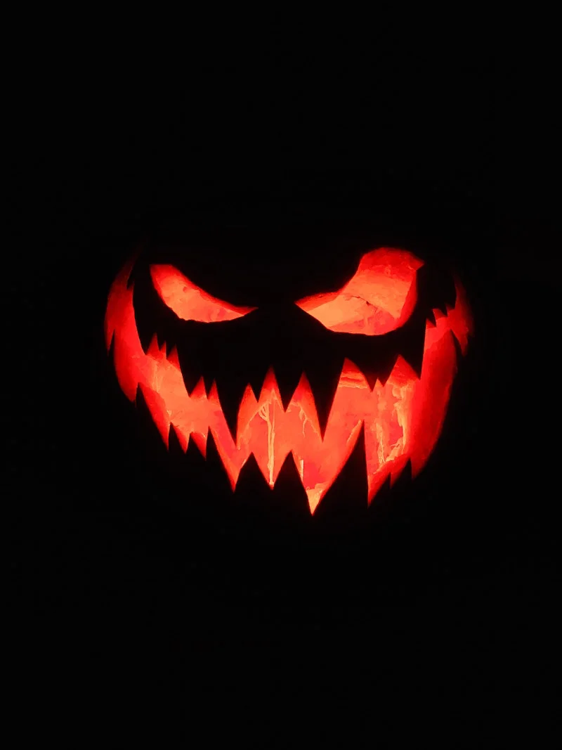 scary halloween pumpkin lit in dark
