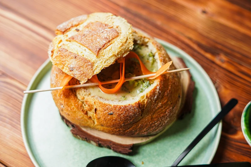 soup from broccoli and cheddar in a bread bowl