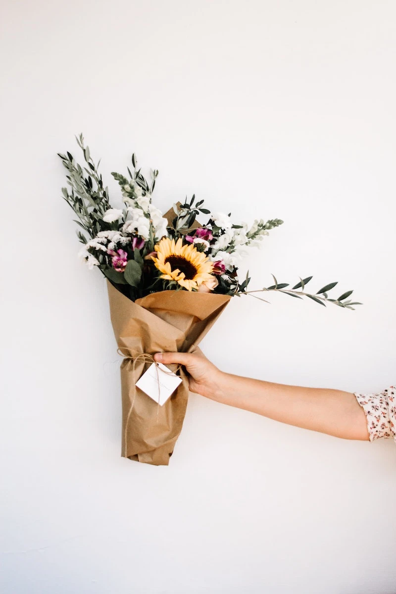 uses for plastic wrap woman holding a bouquet of flowers
