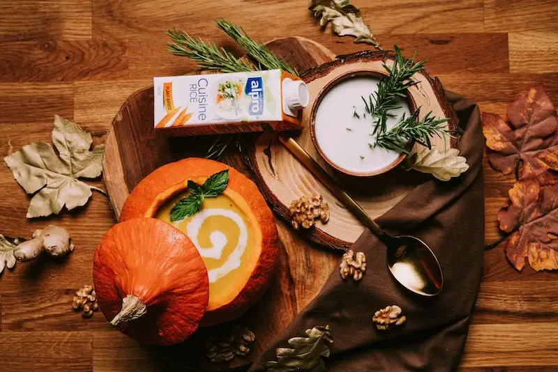 vegan pumpkin soup soup in a carved pumpkin bowl