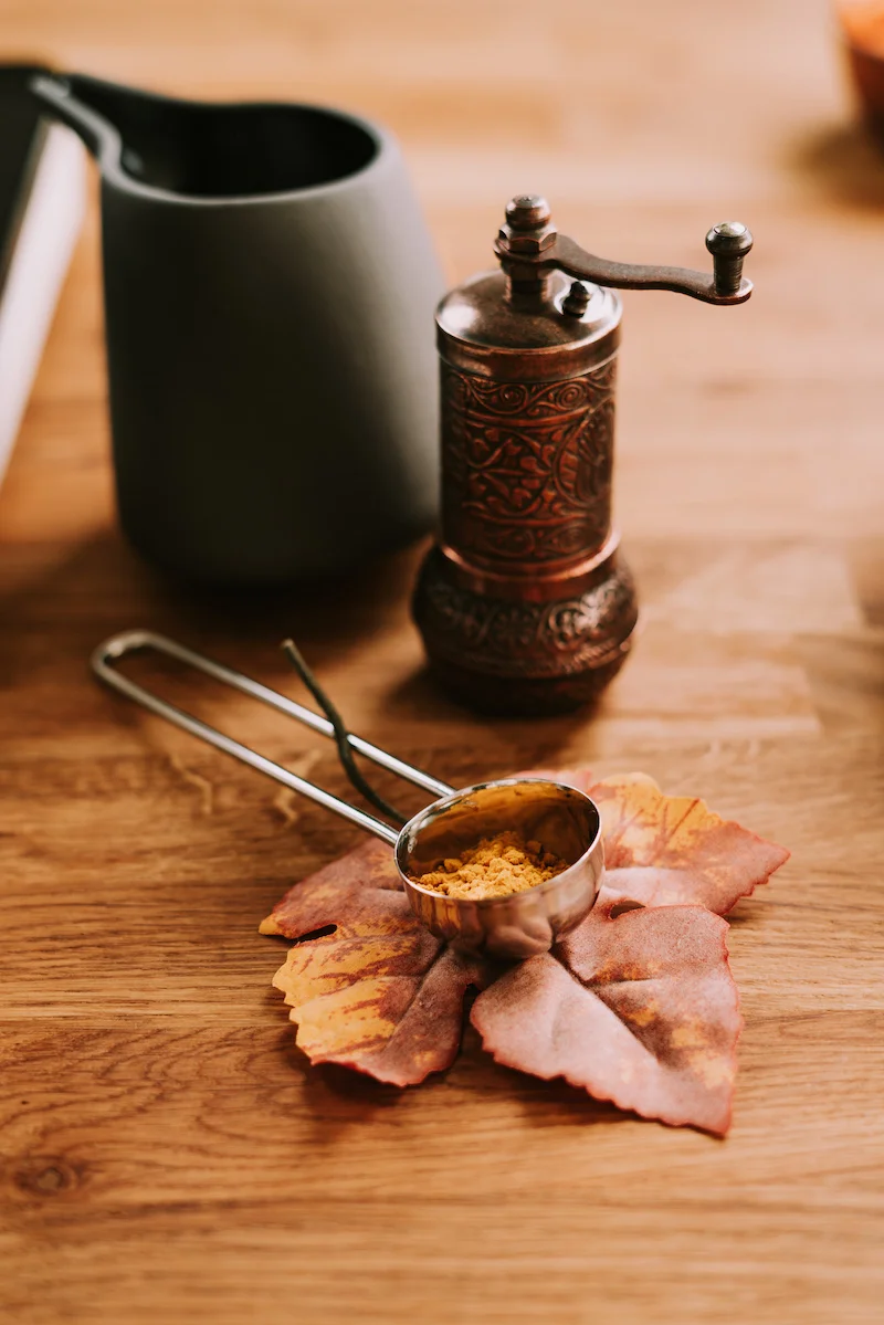 vegan pumpkin soup turmeric in a measuring spoon