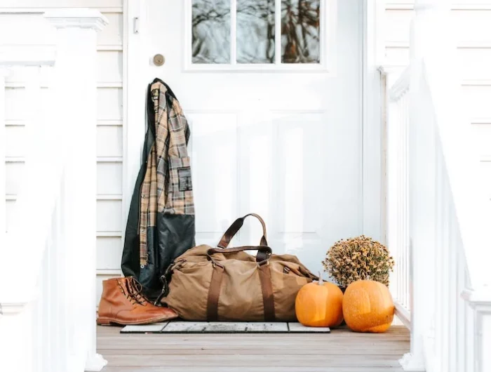 white door with pumpkins and shoes and bag