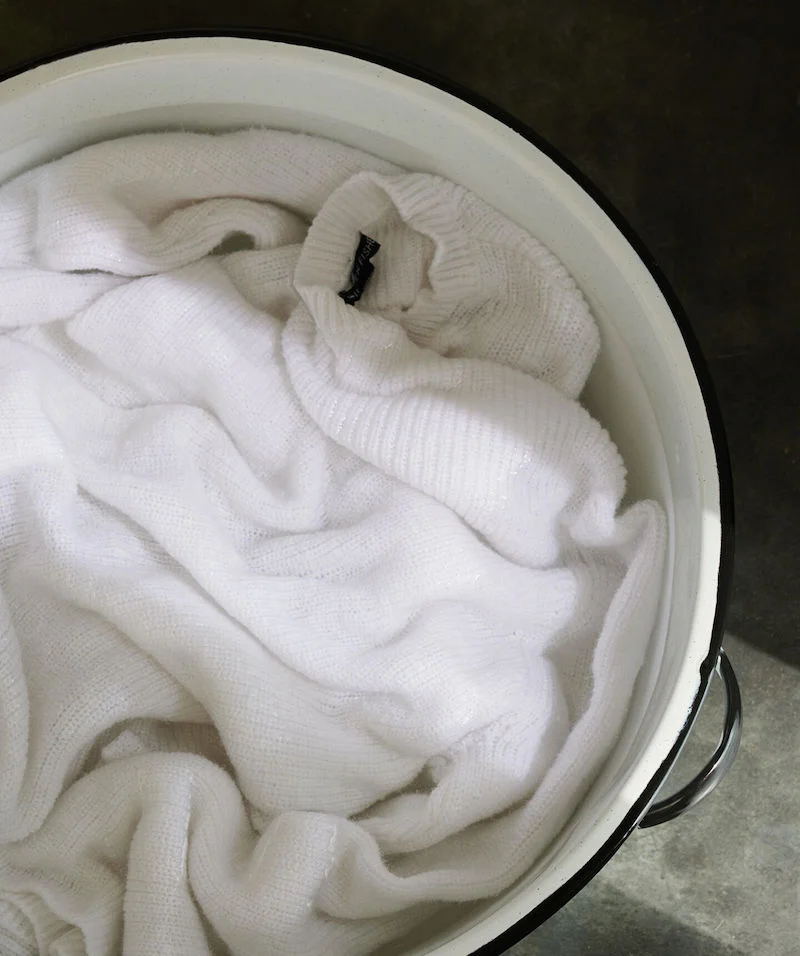 white sweater in a tub of water
