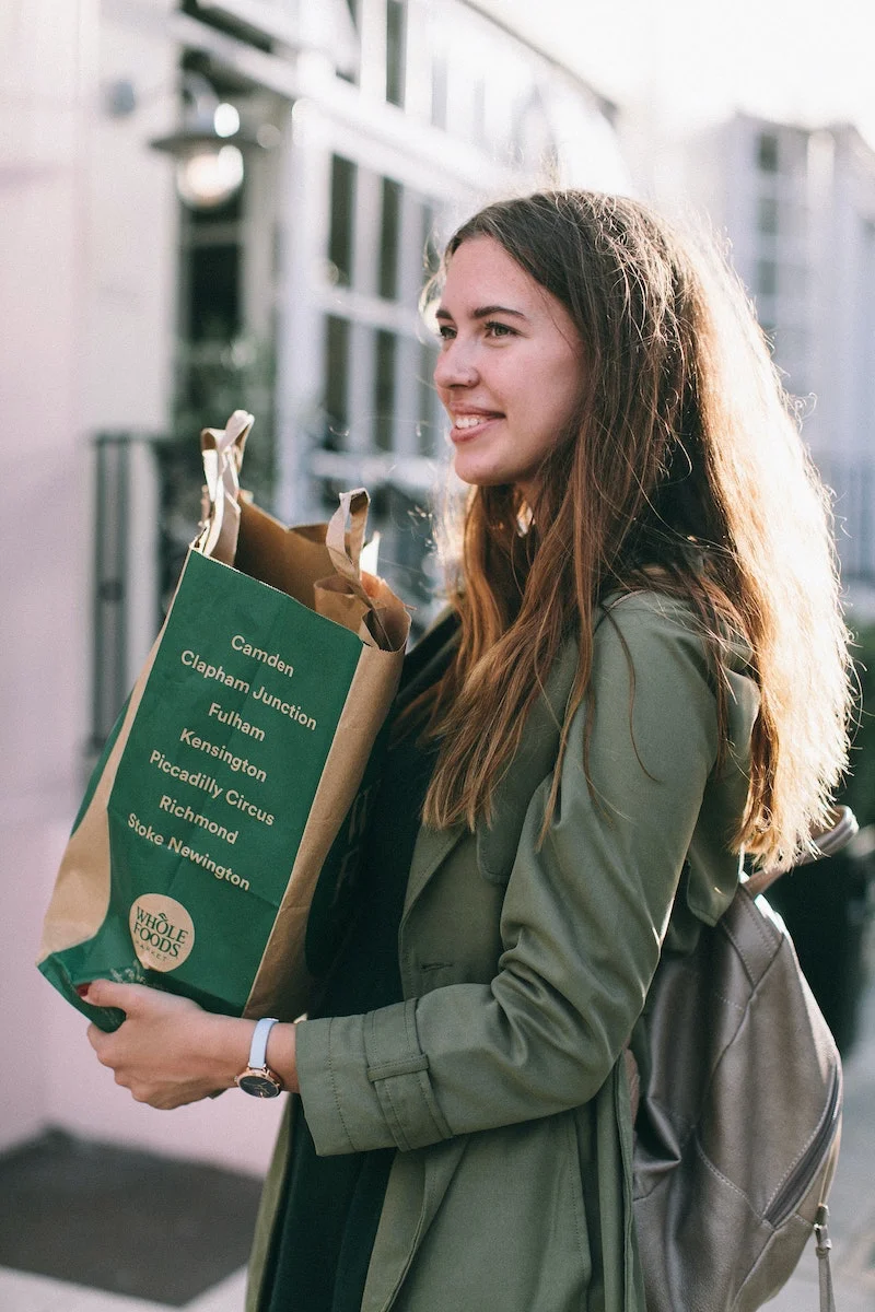 woman holding a paper grocery bag