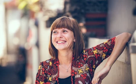 woman smiling while leaning on elbow