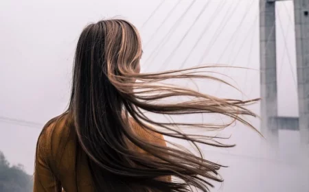 woman with long brown hair flowing in the wind