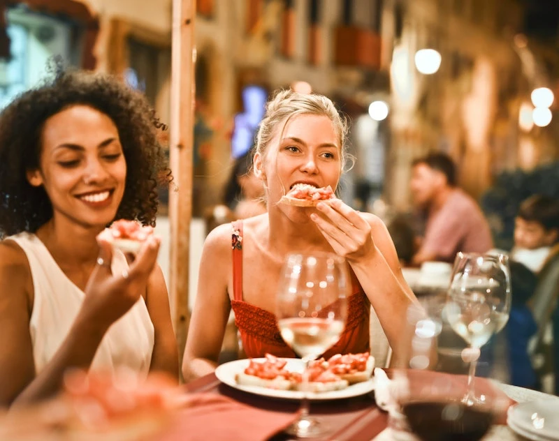 women enjoying bruschetta toast