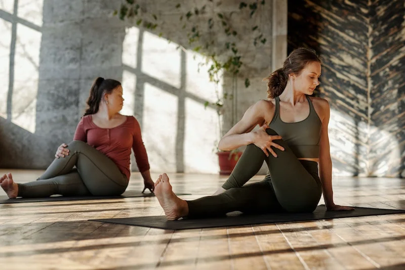 yoga vs pilates women practicing yoga on mats