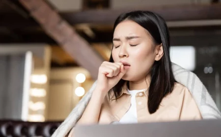 asian woman being ill coughing fist feeling sick home resting with laptop