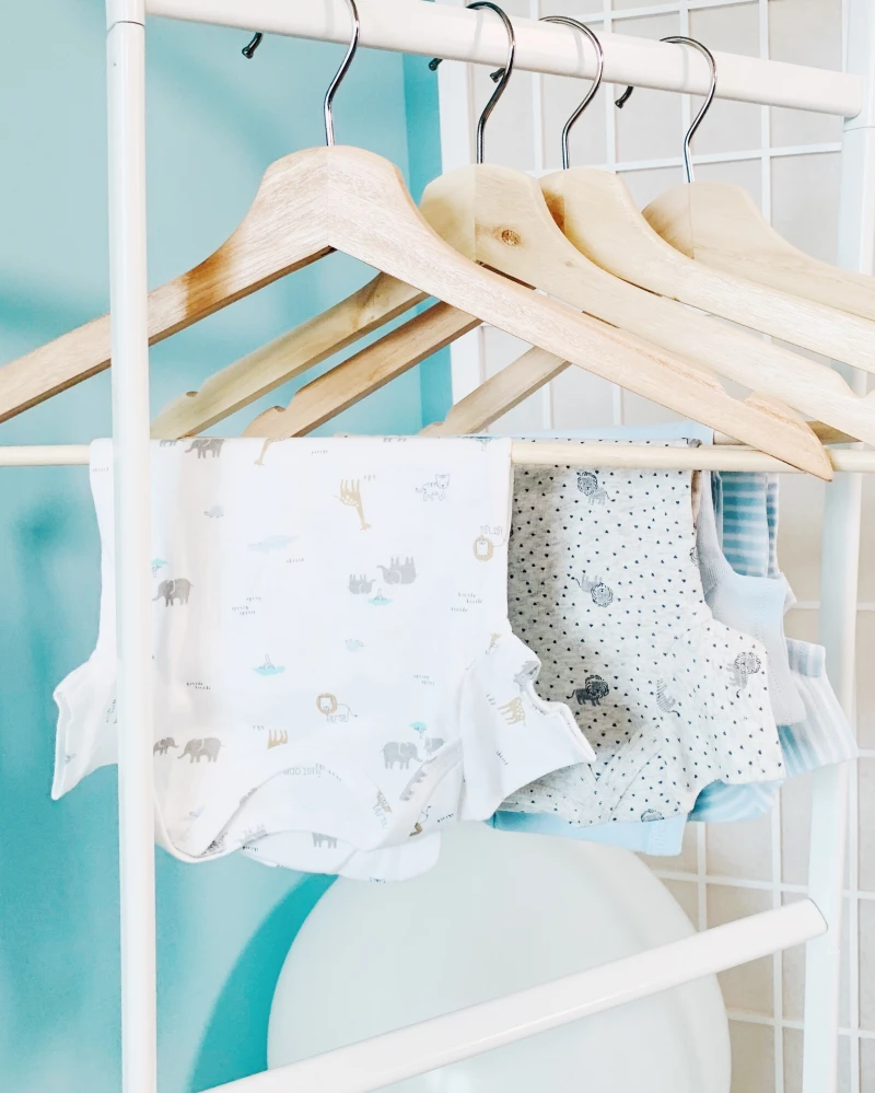 baby clothes hanged to dry on hangers