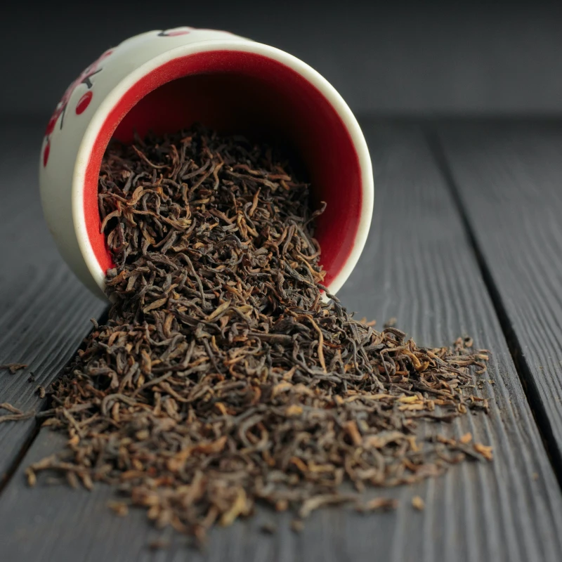 black tea pouring out of a cup