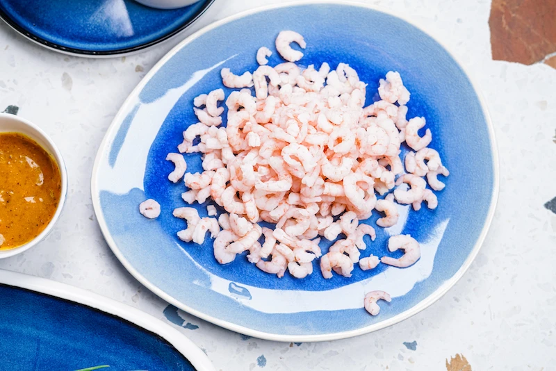 blue plate full of shrimp
