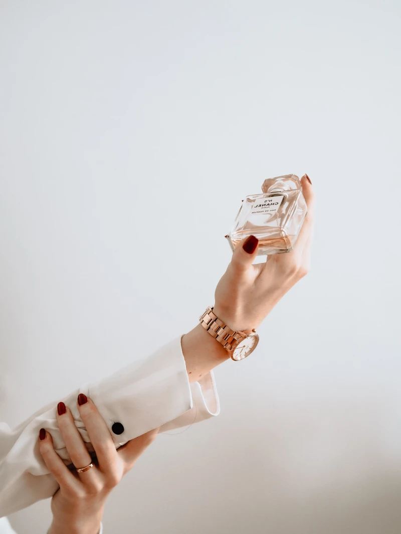 hand holding perfume bottle
