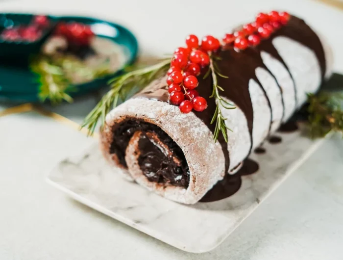 healthy yule log cake with cranberry topping