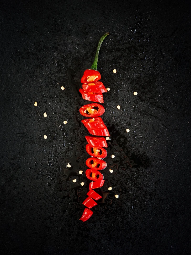 how to clear sinuses red chili pepper sliced on black background