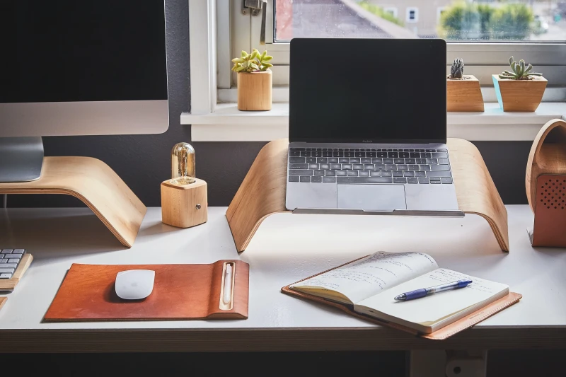 laptop and planner on desk