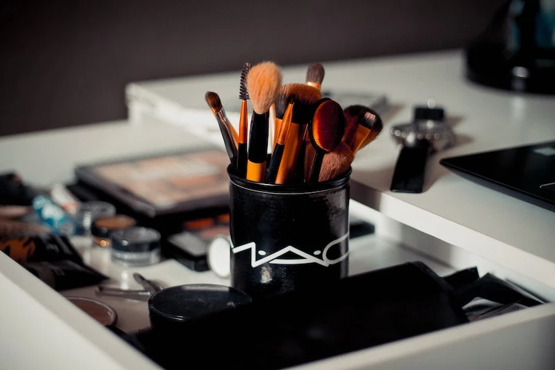makeup brushes in a mac cup