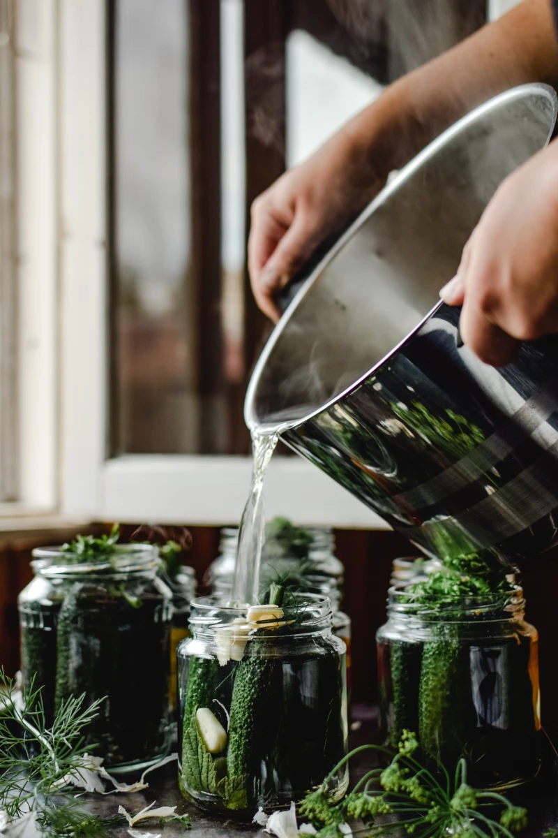 man pickling jars of pickles