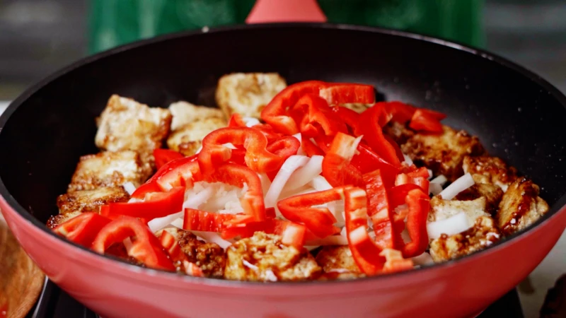 peppers onions and tofu in pan